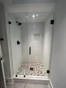 glass shower door with black accents