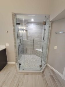 glass enclosed shower with bench