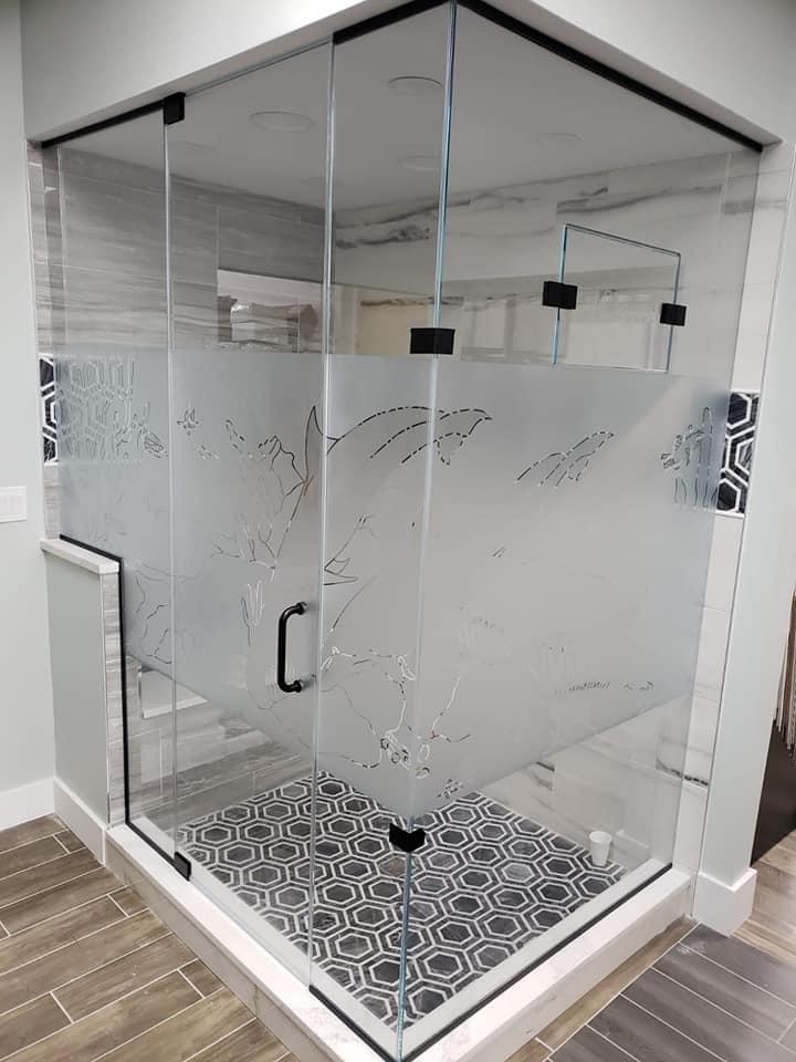 glass shower door with dolphin engravings
