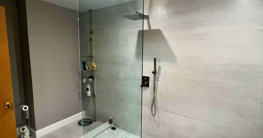 A modern glass panel shower design expertly installed by The Glass Guys.